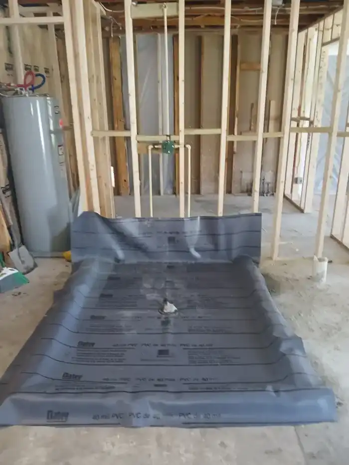 Shower pan liner and drain installation during a bathroom remodel